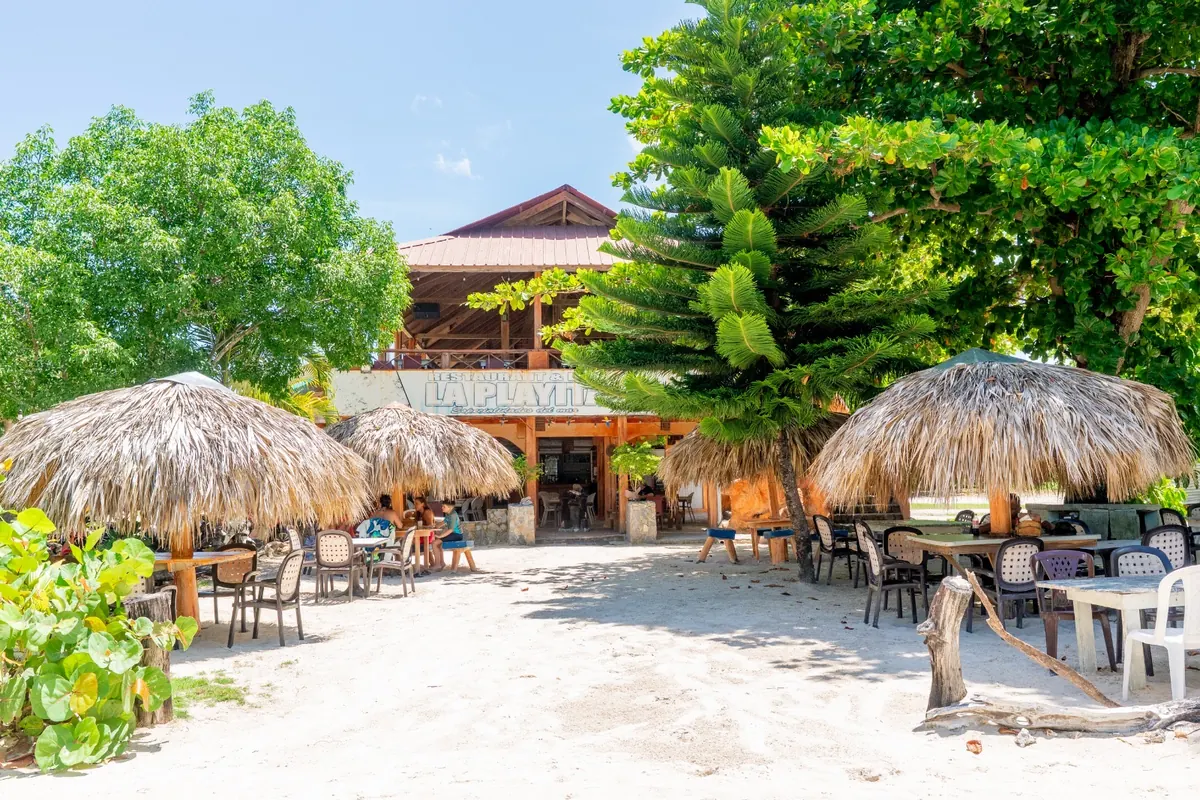 Restaurant La Playita with palm-thatch umbrellas on the sand